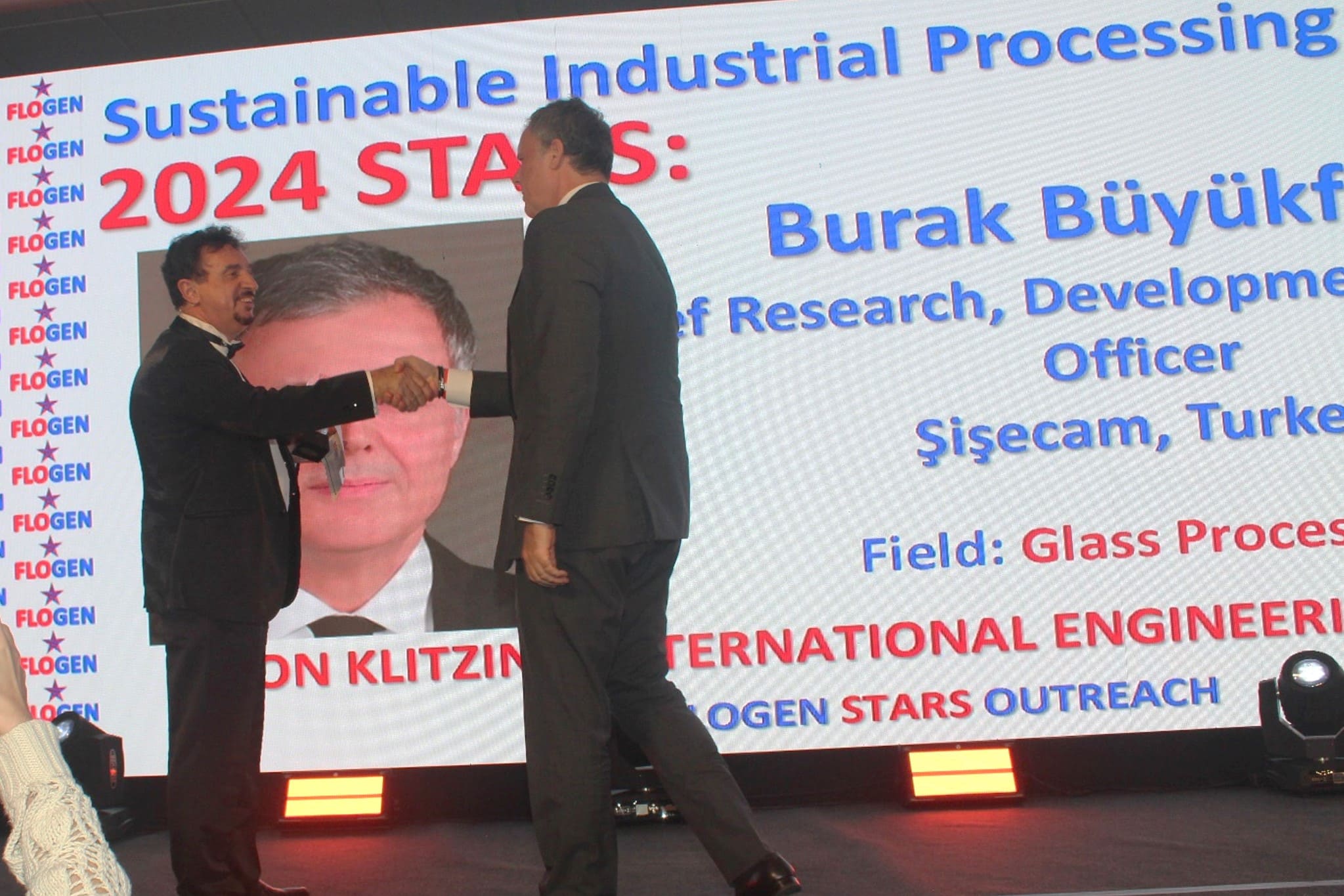 Dr. Florian Kongoli congratulating Mr. Burak Büyükfırat during the FLOGEN SIPS 2024 award ceremony
