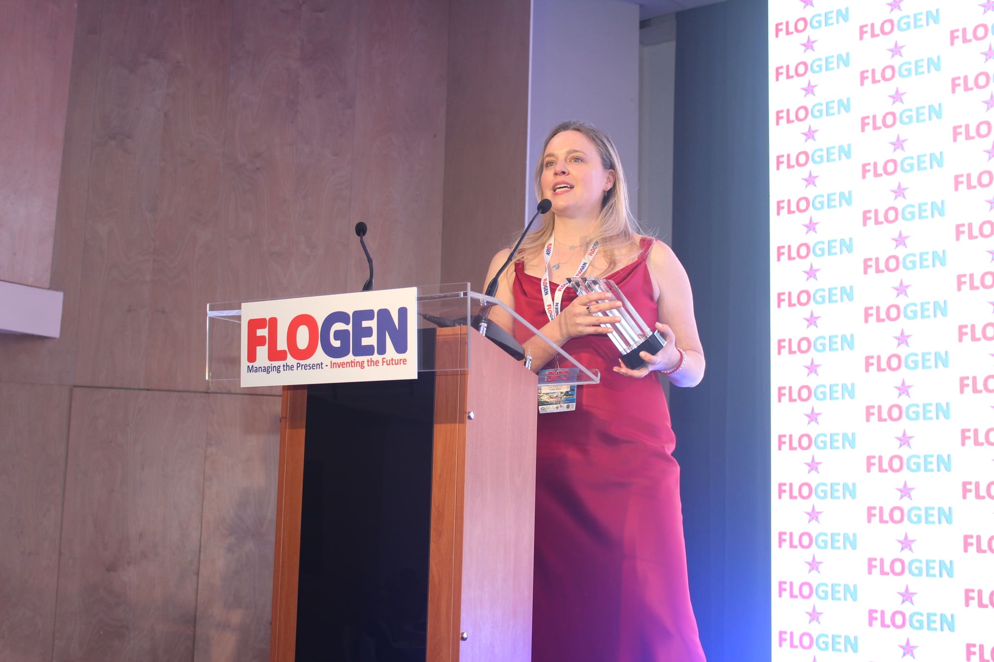 Ms. Emily Hersh delivering an acceptance speech during the FLOGEN SIPS 2024 award ceremony