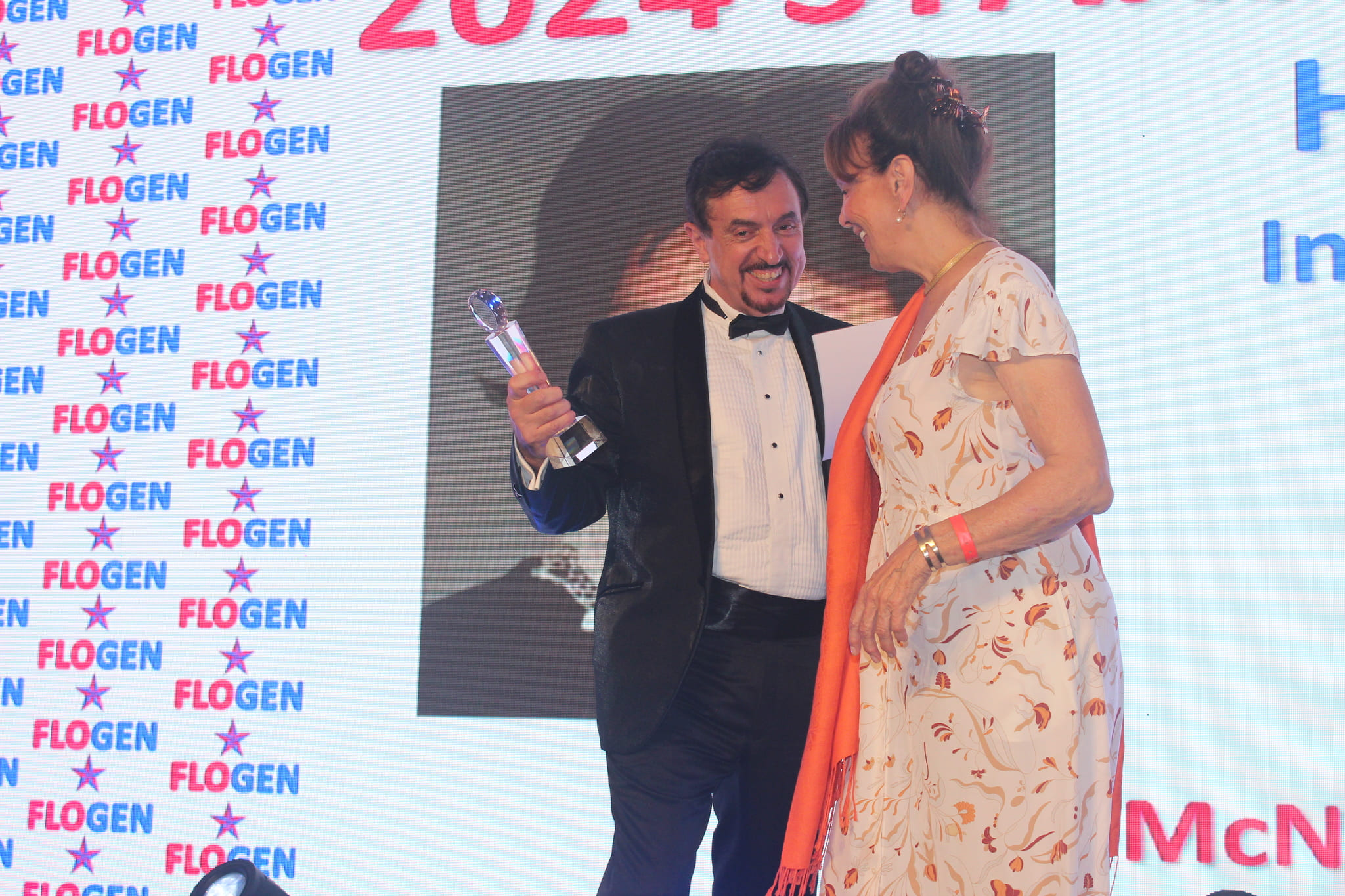 Dr. Florian Kongoli congratulating Honorable Louise Otis during the FLOGEN SIPS 2024 award ceremony