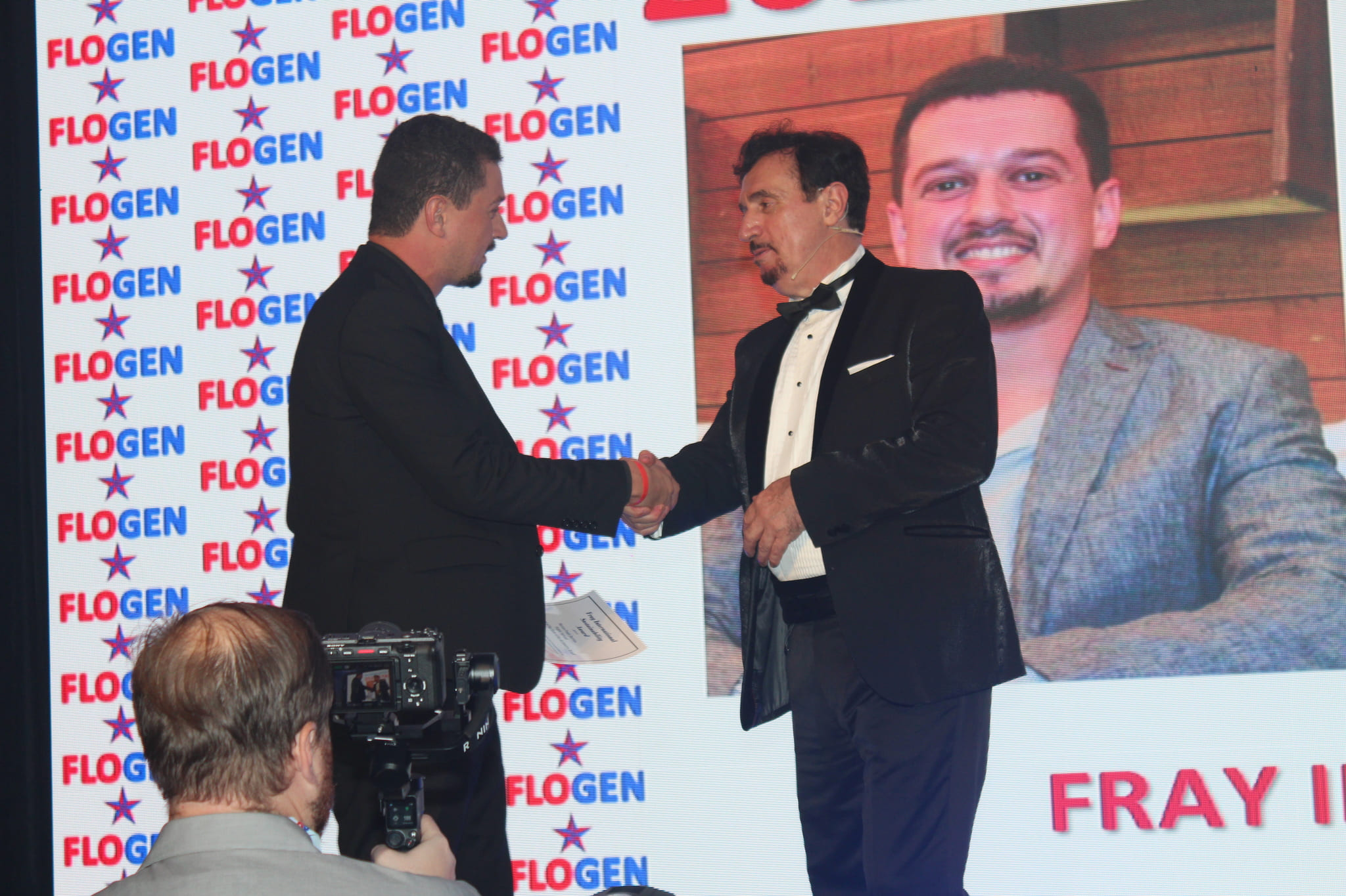 Dr. Florian Kongoli congratulating Mr. Marcos Paulo Barrias during the FLOGEN SIPS 2024 award ceremony