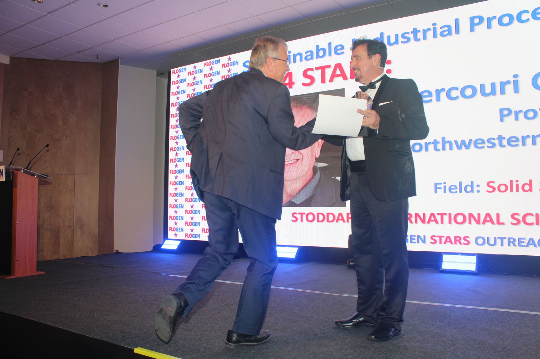 Dr. Florian Kongoli congratulating Dr. Mercouri Kanatzidis during the FLOGEN SIPS 2024 award ceremony