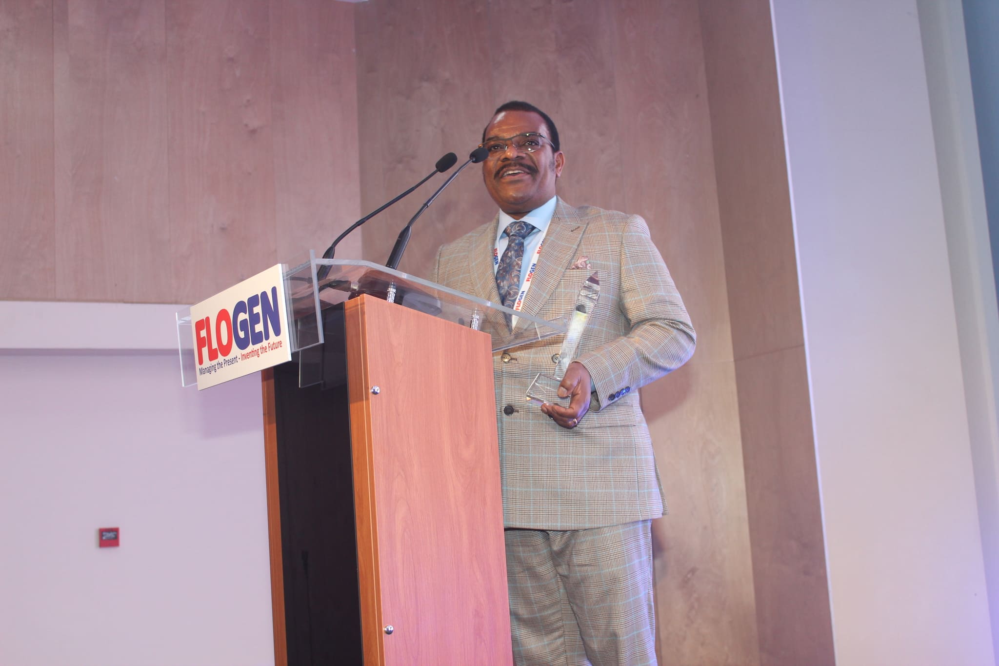 Dr. Michael Makanga delivering an acceptance speech during the FLOGEN SIPS 2024 award ceremony