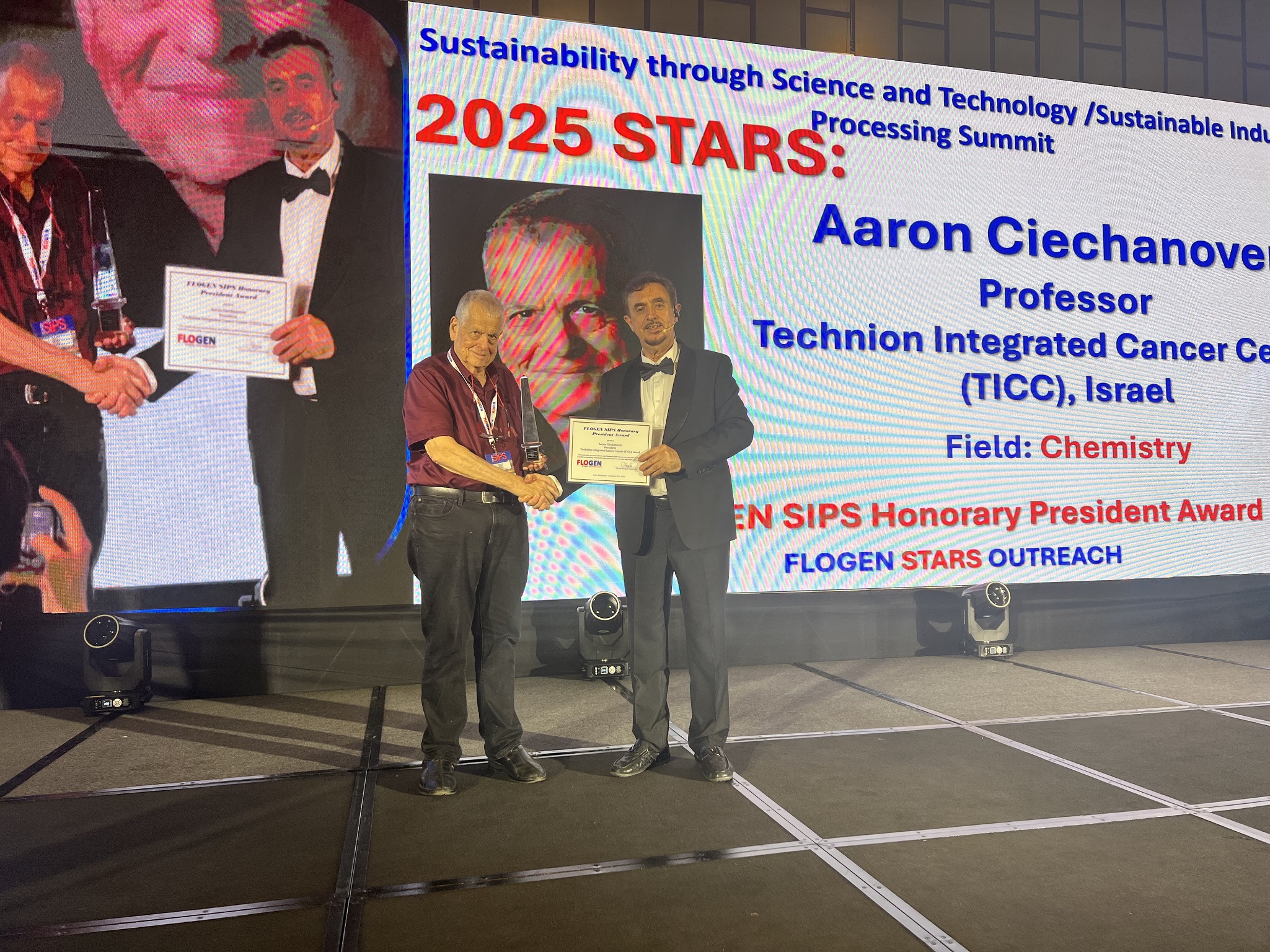 Prof. Aaron Ciechanover receiving the SIPS Honorary President from Dr. Florian Kongoli at FLOGEN SIPS 2025