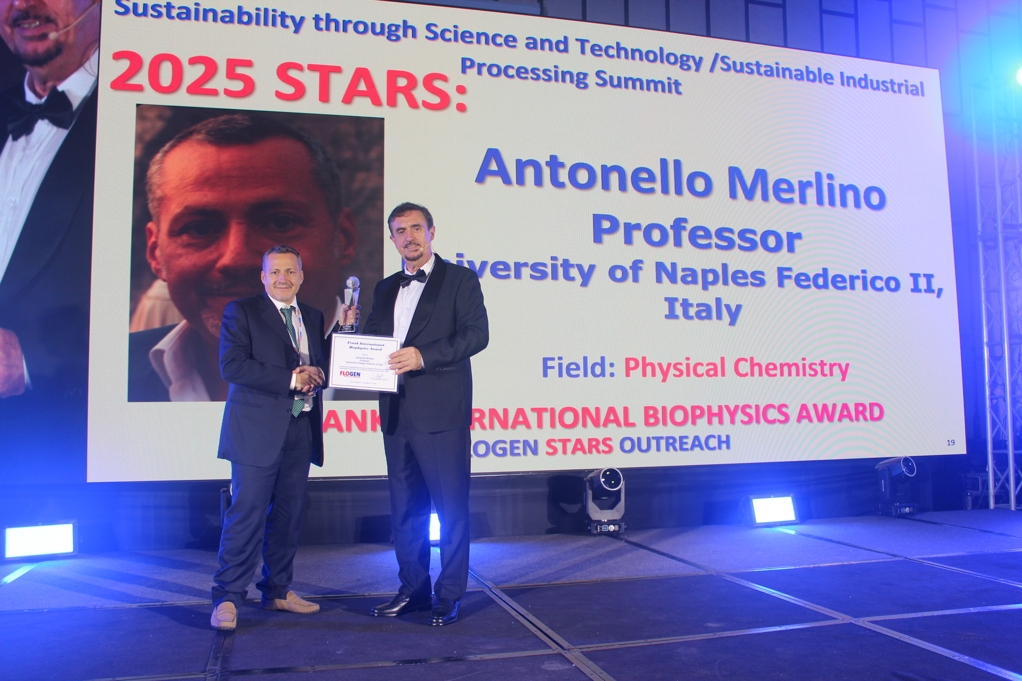 Dr. Antonello Merlino receiving the Frank International Biophysics Award from Dr. Florian Kongoli at FLOGEN SIPS 2025