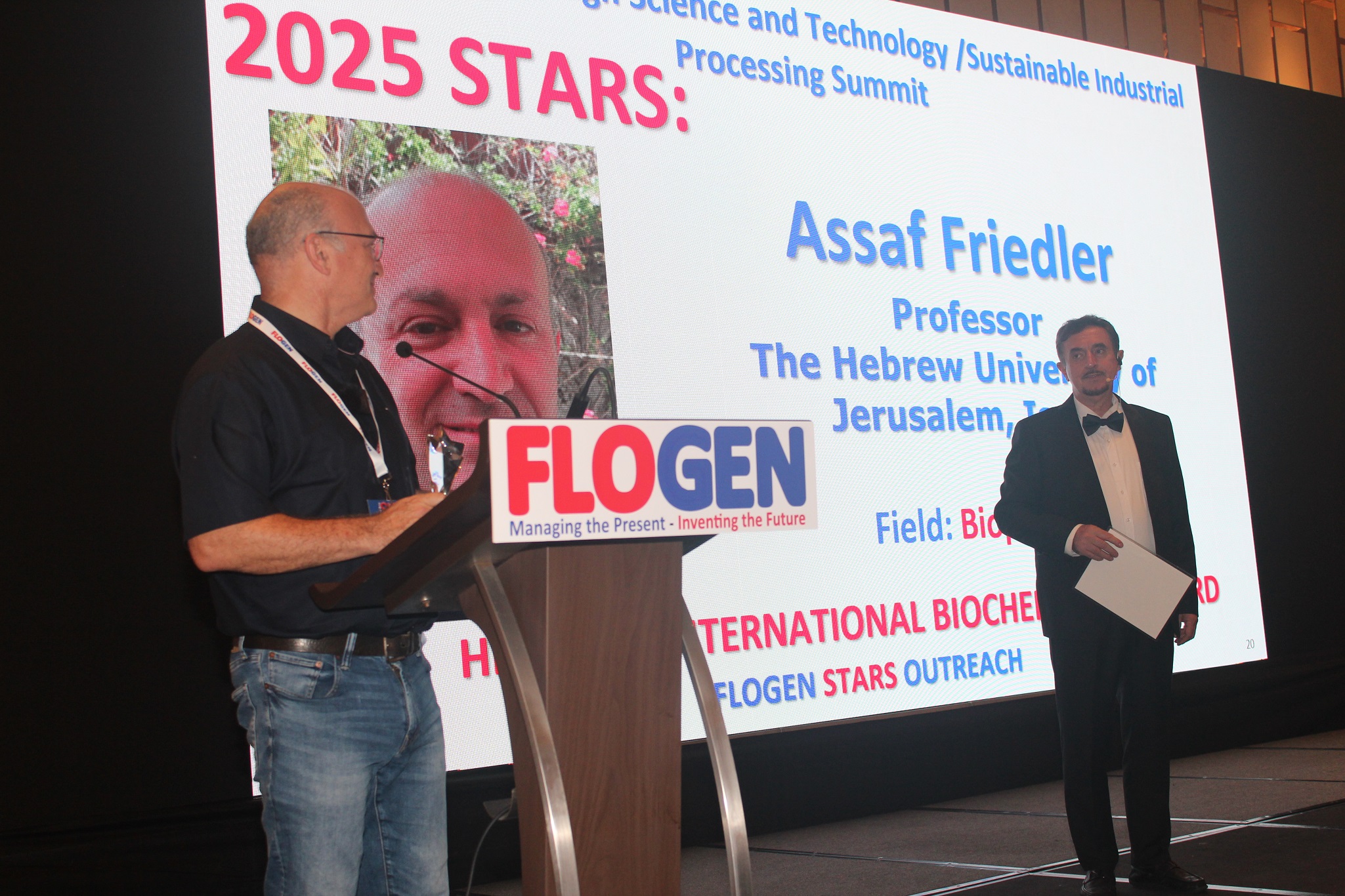 Dr. Assaf Friedler delivering an acceptance speech during the FLOGEN SIPS 2025 award ceremony