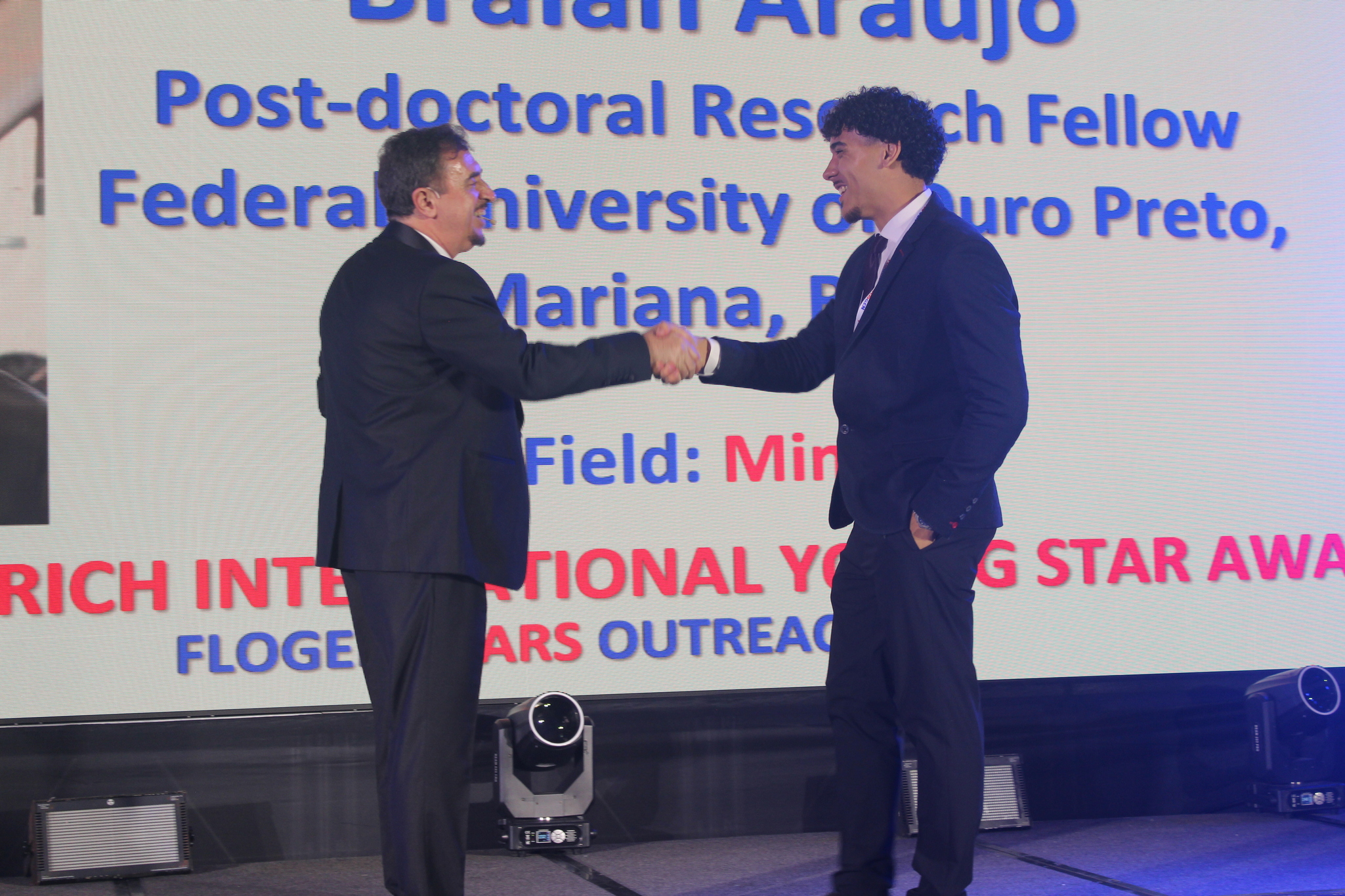Dr. Florian Kongoli congratulating Mr. Braian Araujo during the FLOGEN SIPS 2025 award ceremony