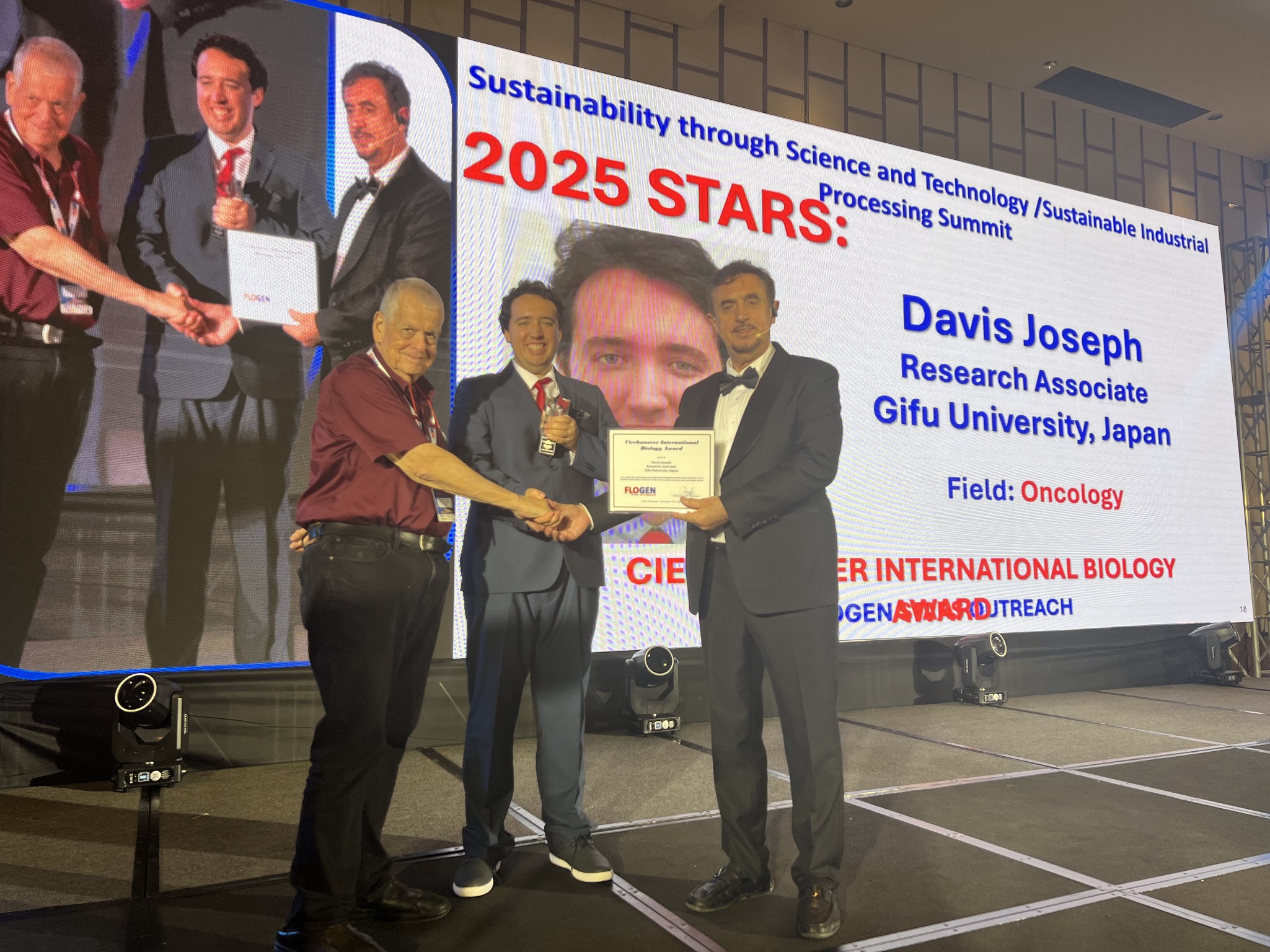 Davis Joseph receiving the Ciechanover International Biology Award from Dr. Florian Kongoli at FLOGEN SIPS 2025