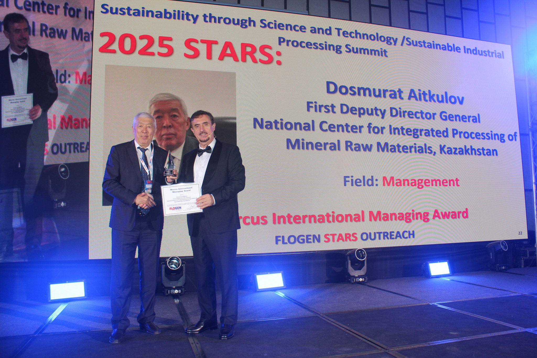Dr. Dosmurat Aitkulov receiving the Marcus International Managing Award from Dr. Florian Kongoli at FLOGEN SIPS 2025