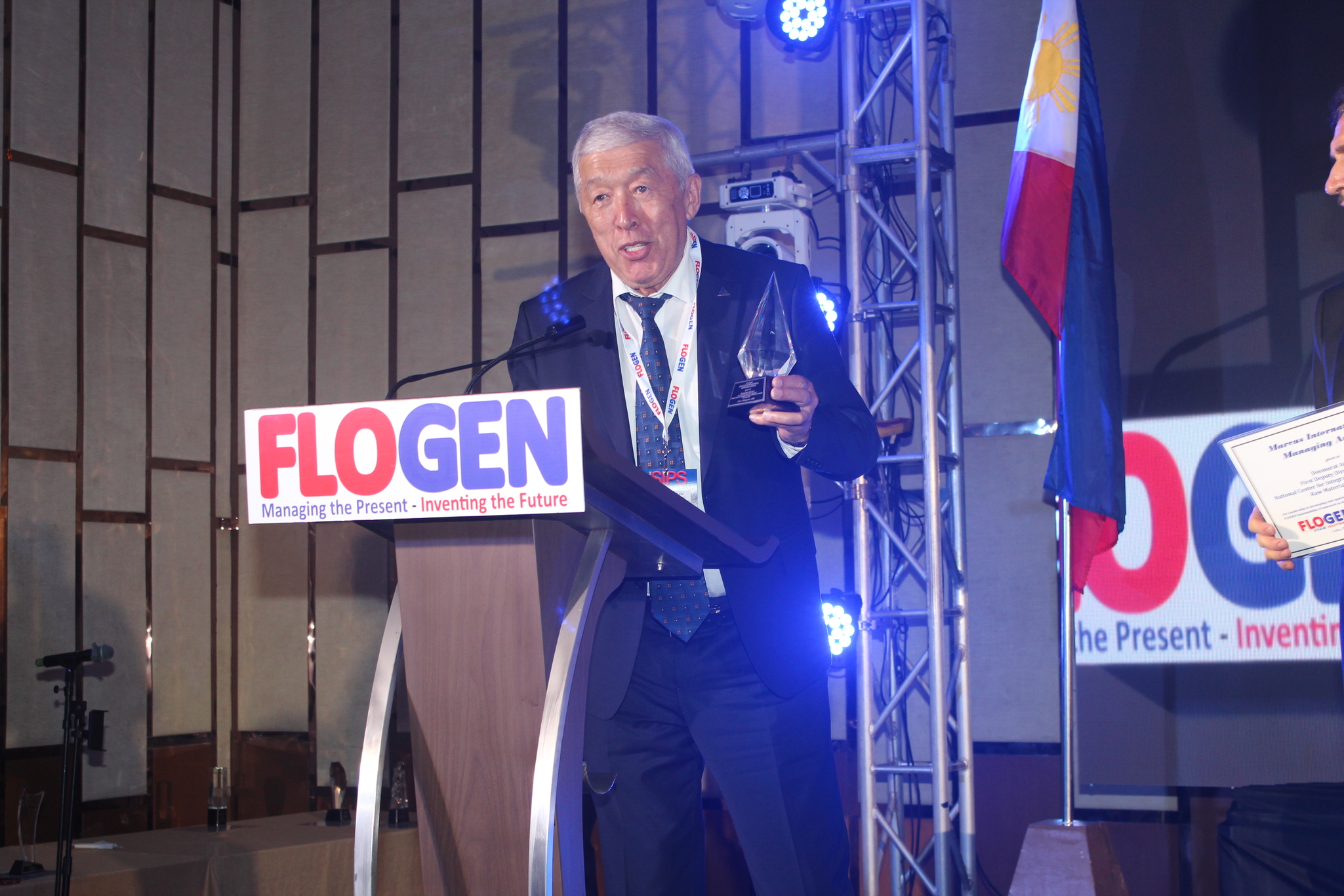 Dr. Dosmurat Aitkulov delivering an acceptance speech during the FLOGEN SIPS 2025 award ceremony