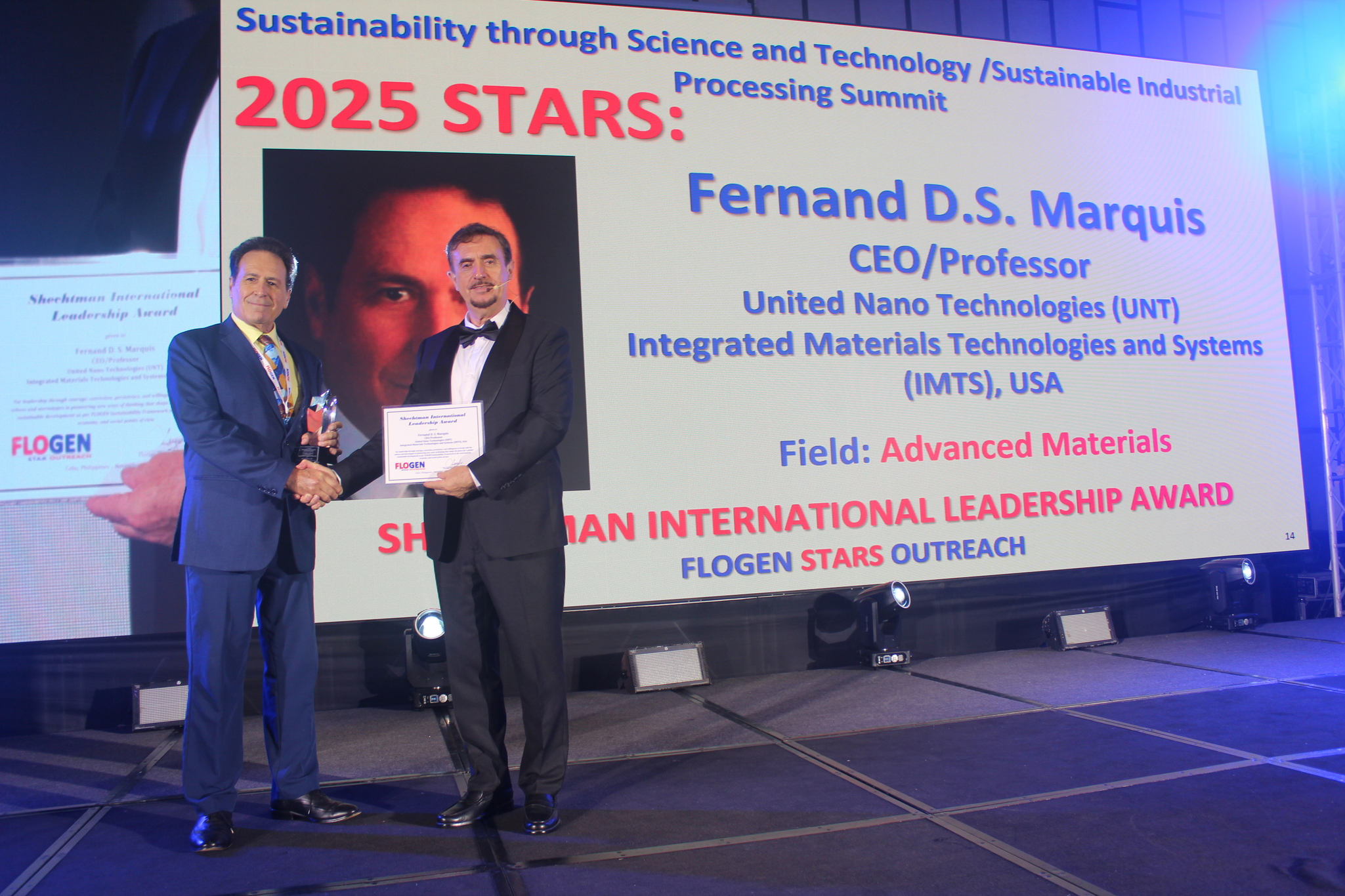 Dr. Fernand Marquis receiving the Shechtman International Leadership Award from Dr. Florian Kongoli at FLOGEN SIPS 2025