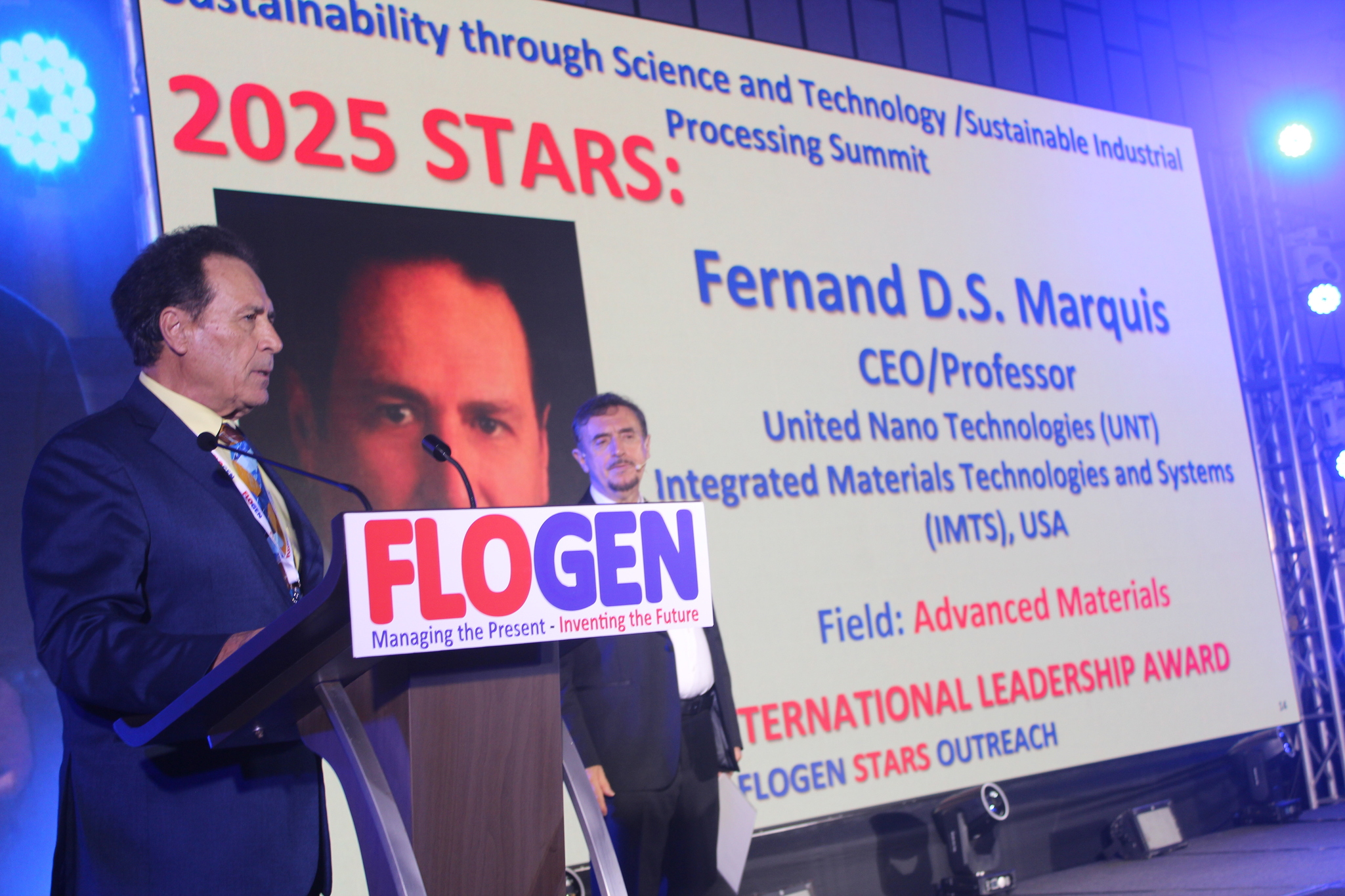 Dr. Fernand Marquis delivering an acceptance speech during the FLOGEN SIPS 2025 award ceremony