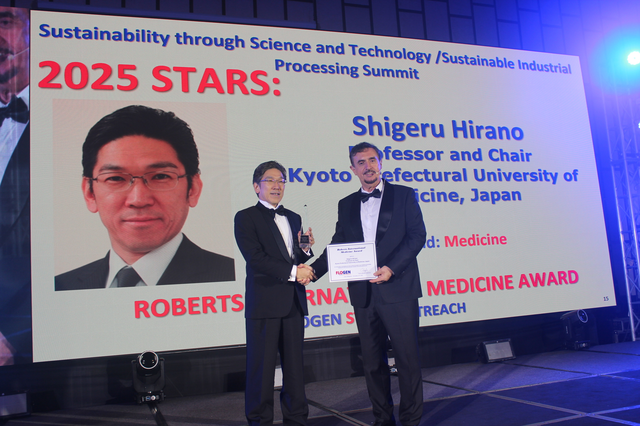 Dr. Shigeru Hirano receiving the Roberts International Medicine Award from Dr. Florian Kongoli at FLOGEN SIPS 2025